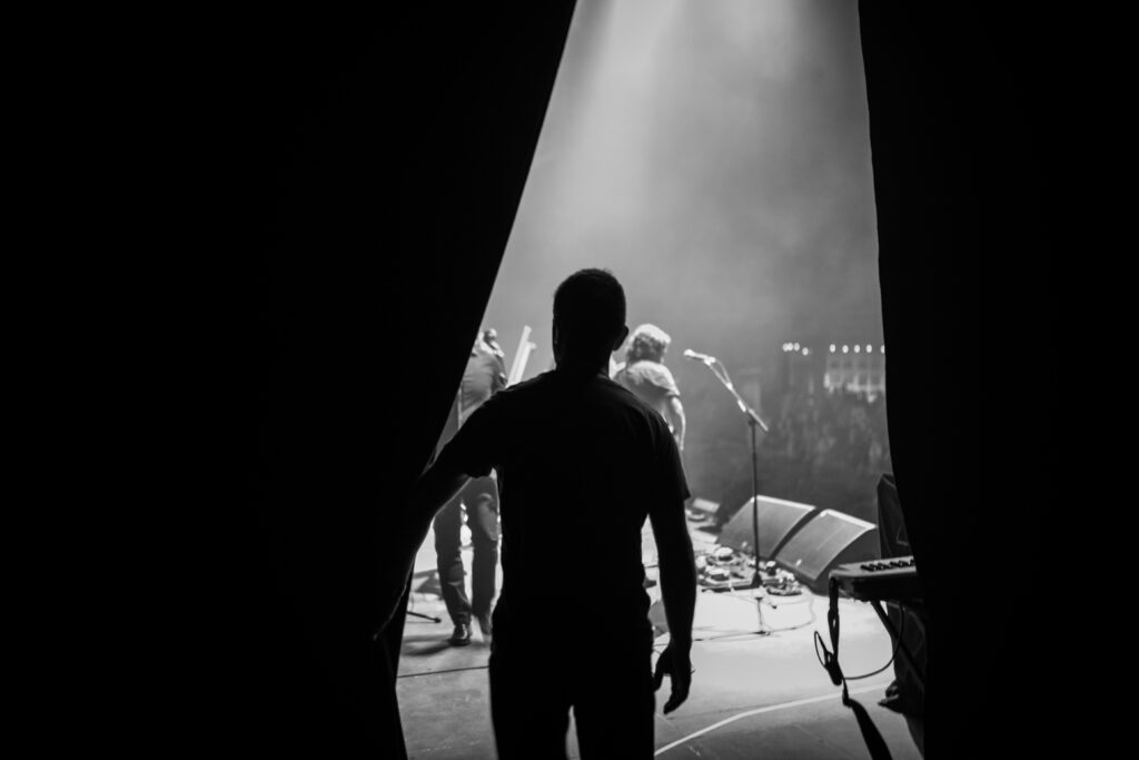 Rear View Of Silhouette Man about to go on Stage