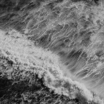 A black and white nature photograph of the ocean