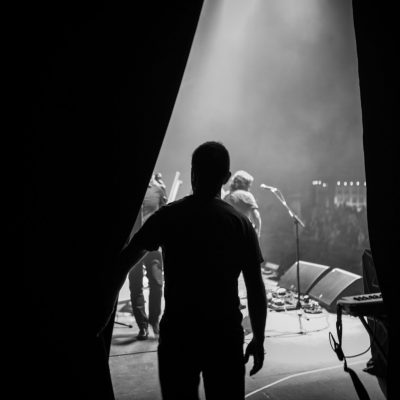 Rear View Of Silhouette Man Standing On Stage Rear View Of Silhouette Man about to go on Stage